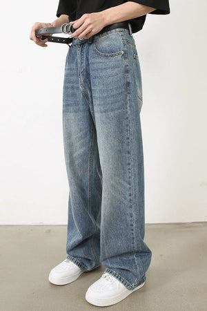 Wide-leg washed denim jeans in medium blue with a relaxed fit and distressed details.