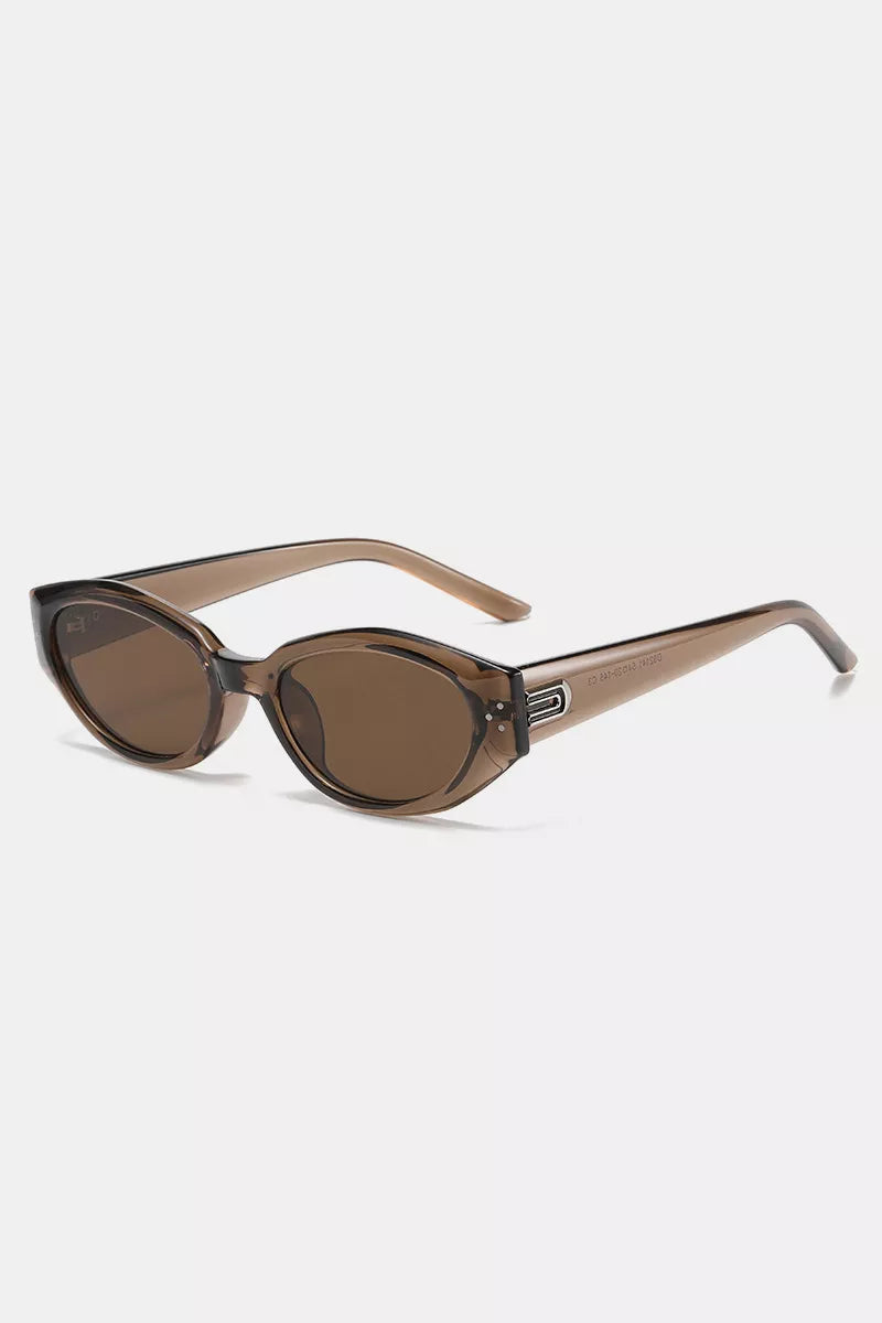 Chic cat-eye sunglasses in translucent brown with metallic accents and brown lenses.