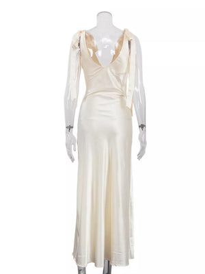 Cream satin maxi dress with tie shoulder straps and deep V-neckline