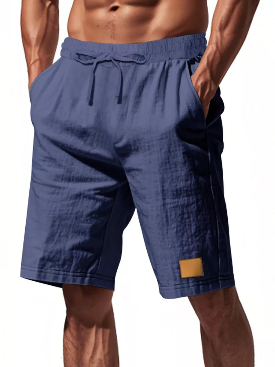 Men's navy blue chino shorts with drawstring waist and side pockets.