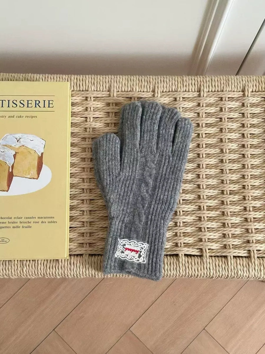 Gray acrylic cable knit gloves with decorative patch detail