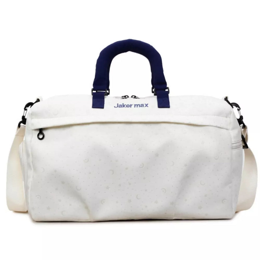 Cream white duffel bag with crescent moon and star pattern, navy handles and strap.