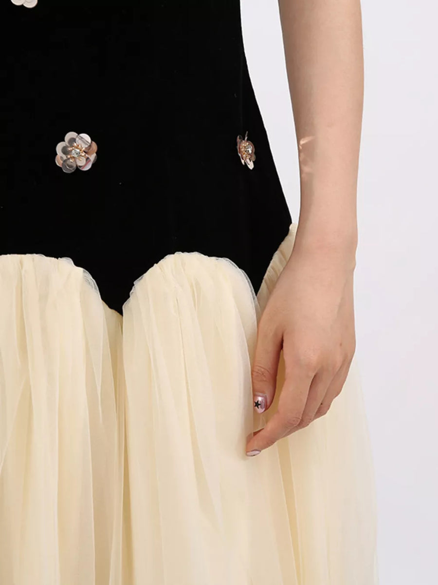 Black velvet dress with sequin floral appliques and a cream tulle skirt.