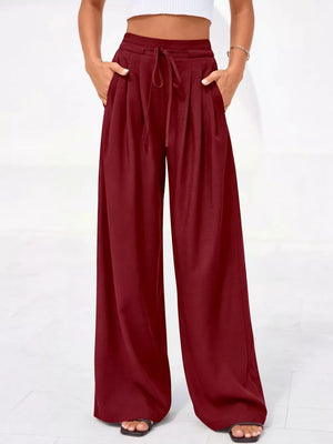 Burgundy high-waisted pleated pants with drawstring and pockets