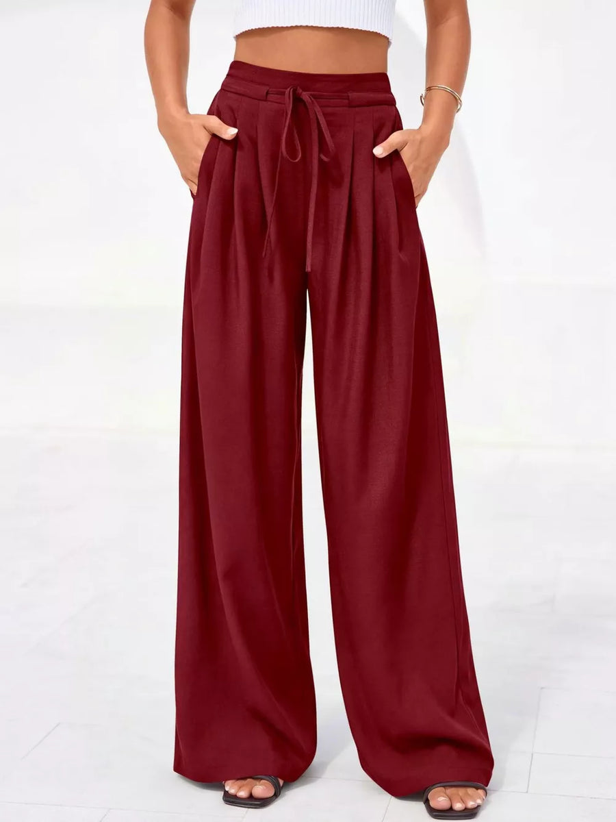 Burgundy high-waisted pleated pants with drawstring and pockets