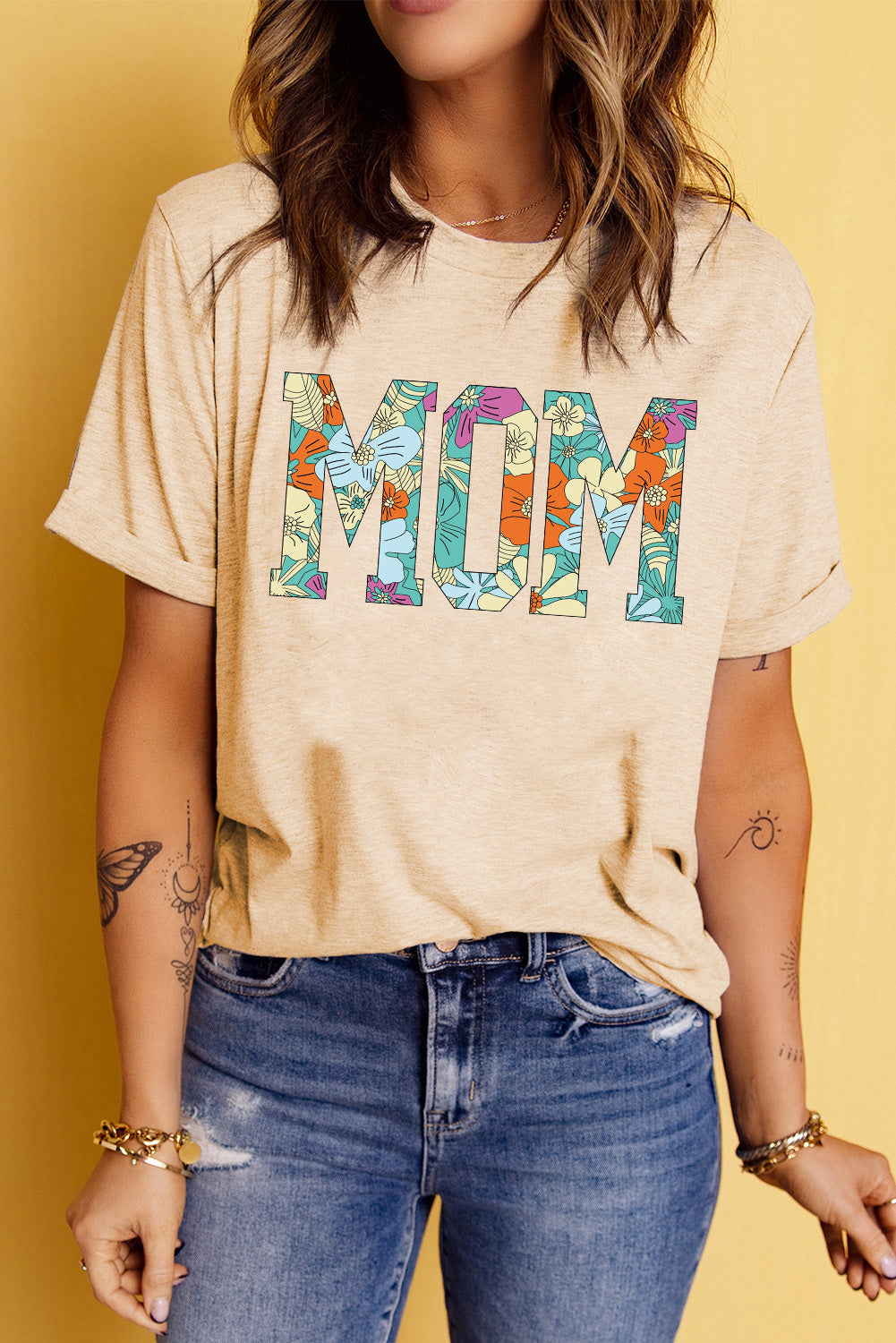Light apricot t-shirt with colorful floral MOM graphic, short sleeves, crew neck.