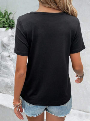 Black short-sleeve t-shirt with cutout detail, styled with denim shorts.