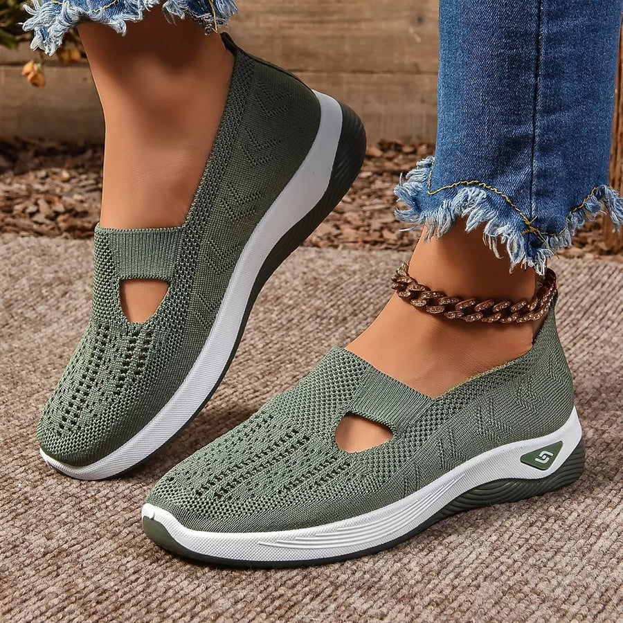 Green breathable mesh slip-on shoes with white soles and a cut-out detail.