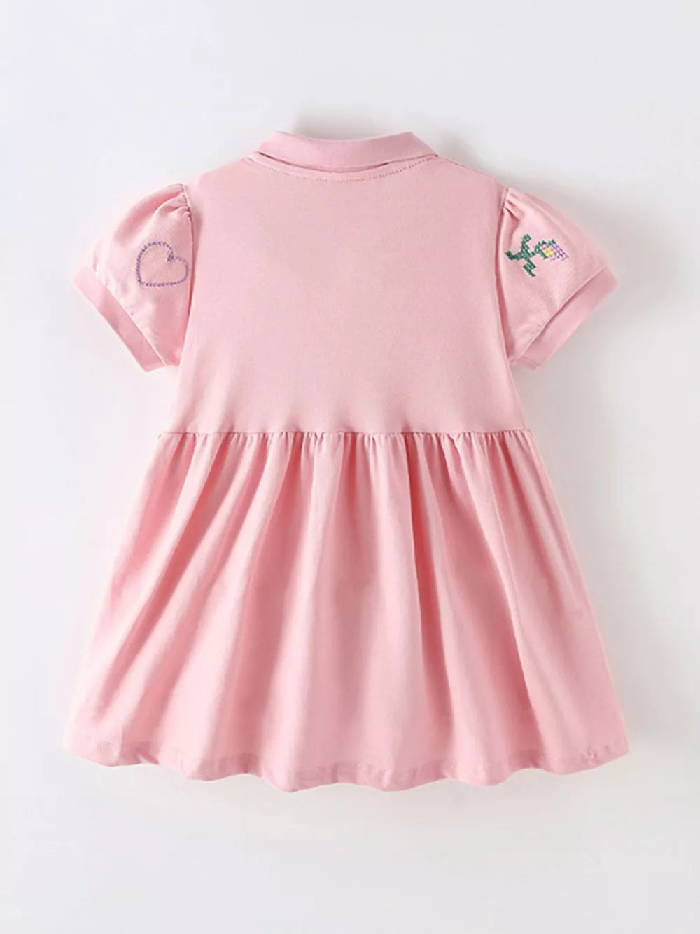 Pink cotton blend baby dress with embroidered heart and flower details on sleeves.