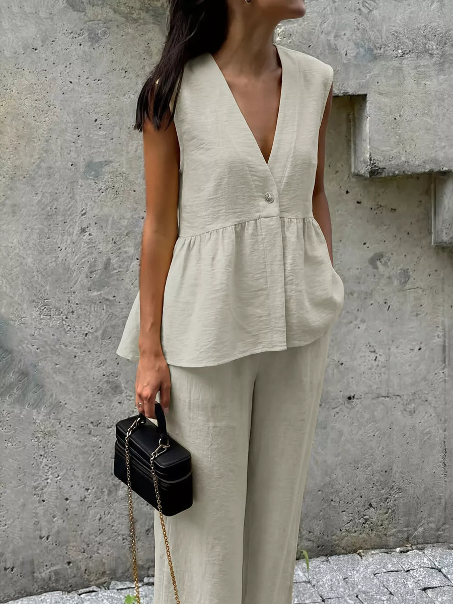 Linen blend sleeveless peplum top with V-neck and wide-leg pants in beige.