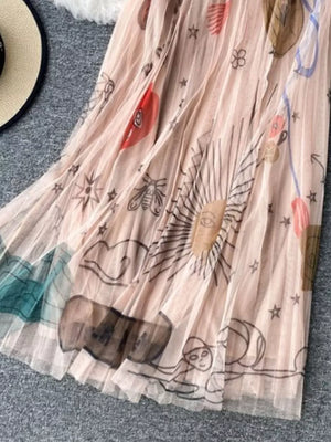 Pleated pink tulle skirt with whimsical sunburst and abstract print.