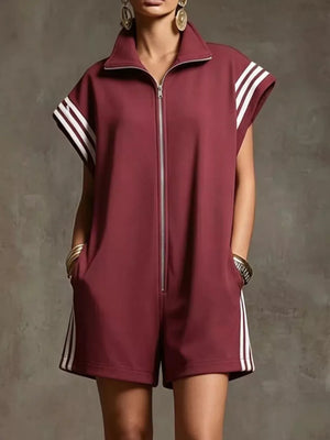 Burgundy zip-up romper with white stripes on sleeves and sides, featuring pockets.