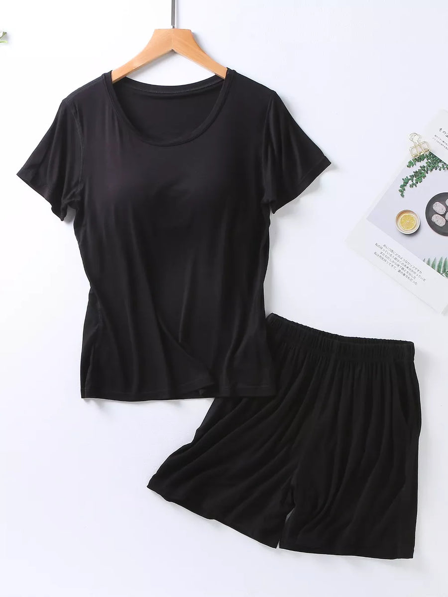 Black two-piece pajama set with crew neck t-shirt and elastic waist shorts.