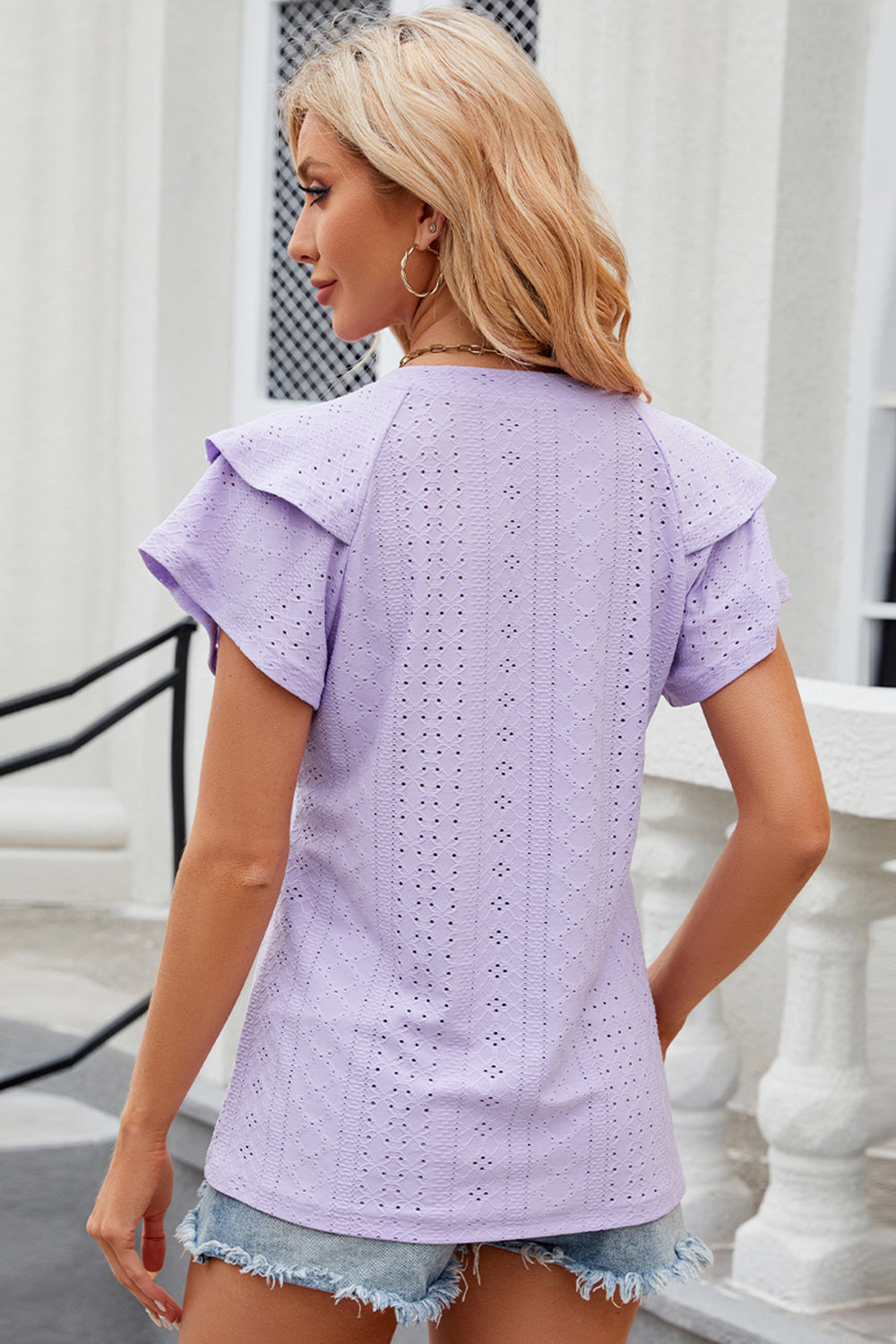 Lavender eyelet blouse with flutter sleeves and a detailed pattern.