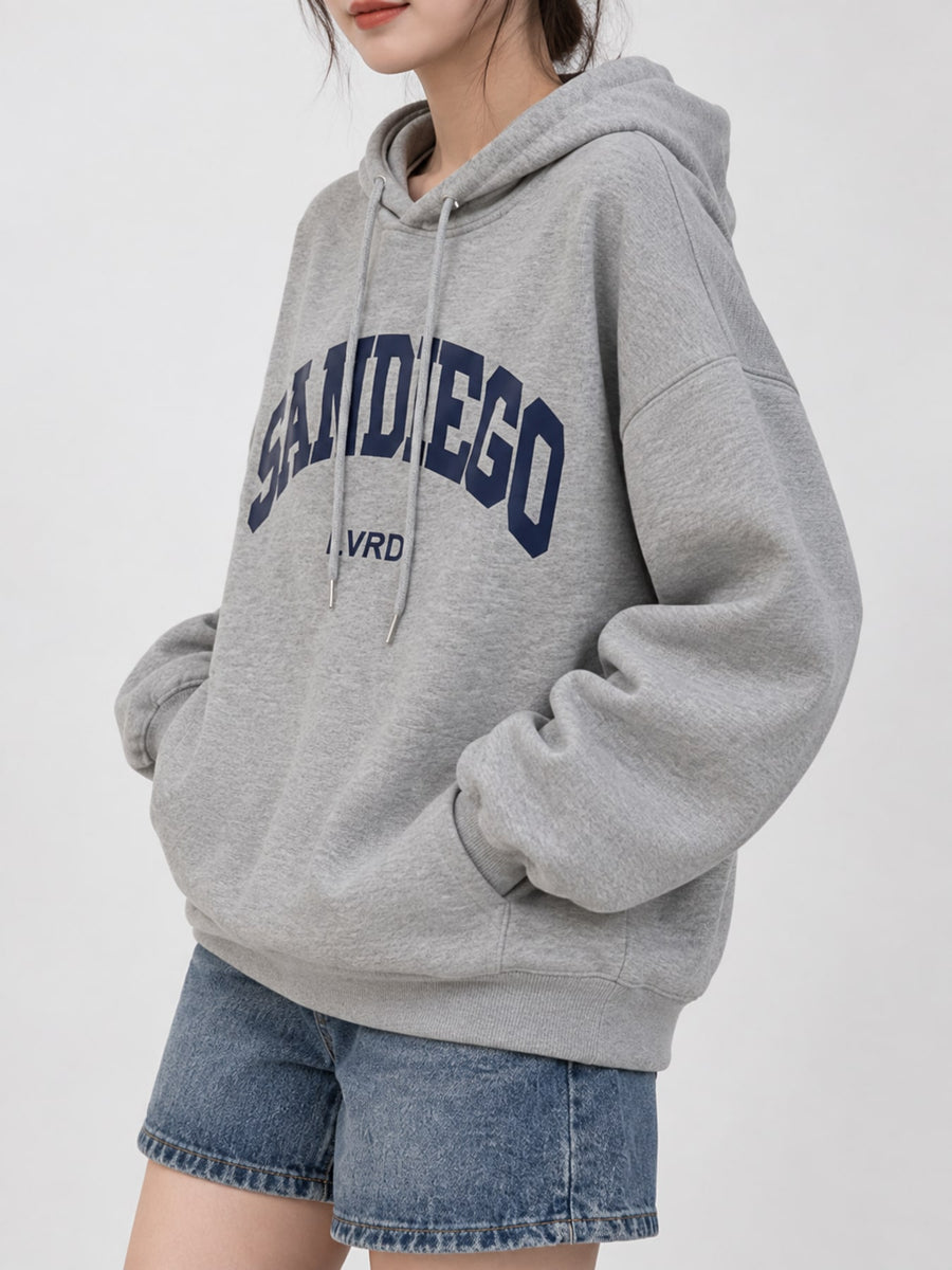 Red pullover hoodie featuring oversized and graphic-print