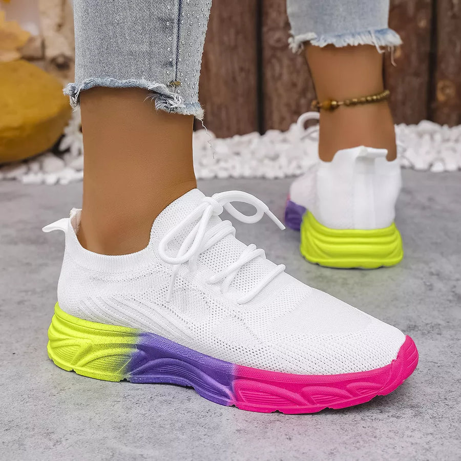 White mesh lace-up sneakers with a vibrant gradient sole in yellow, purple, and pink.