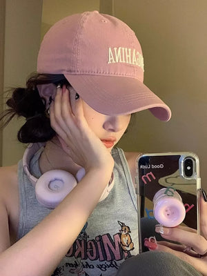 Pink cotton baseball cap with mirrored letter embroidery and curved brim.