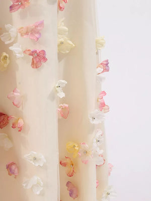 Romantic floral applique tulle maxi dress in ivory with pastel floral details and pearl accents.