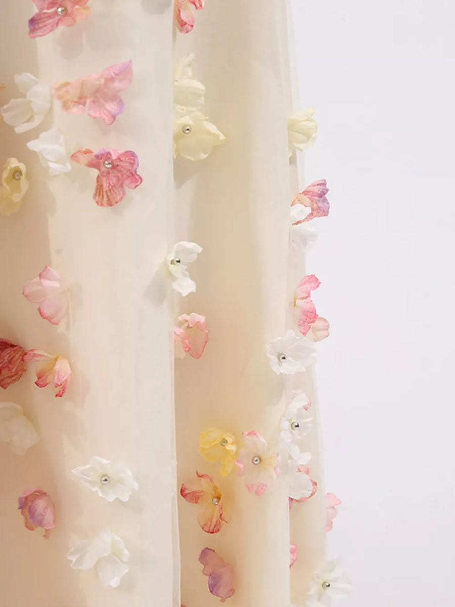 Romantic floral applique tulle maxi dress in ivory with pastel floral details and pearl accents.
