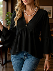 Black V-neck blouse with flounce sleeves and a single button detail.
