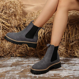 Gray suede platform ankle boots with chunky sole and elastic side panels.
