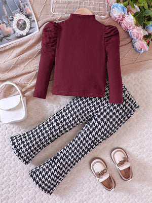 Baby girl's wine red ribbed top with puff sleeves and houndstooth pants.