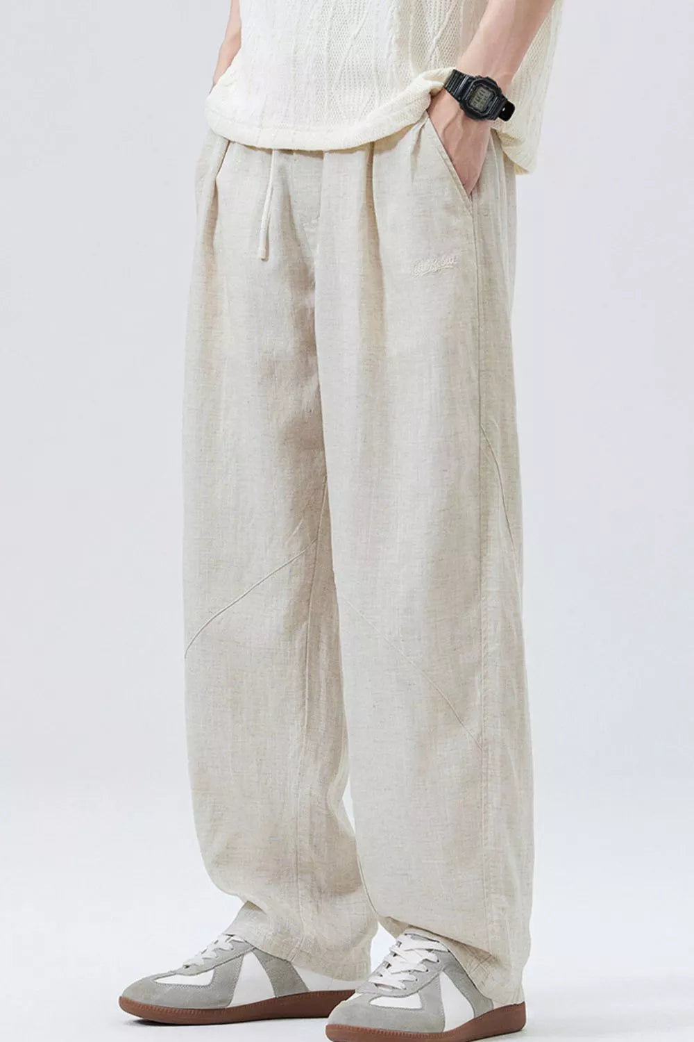 Loose fit apricot drawstring casual pants with a relaxed cut and subtle logo detail.