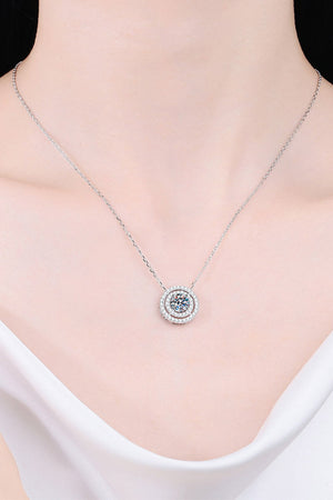 Silver halo diamond-framed pendant necklace with a central sparkling stone.
