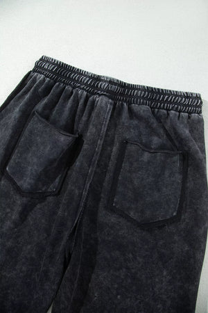 charcoal gray barrel pants with raw seam and N/A