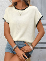 Off-white ribbed short-sleeve sweater with black contrast trim neckline and hem.