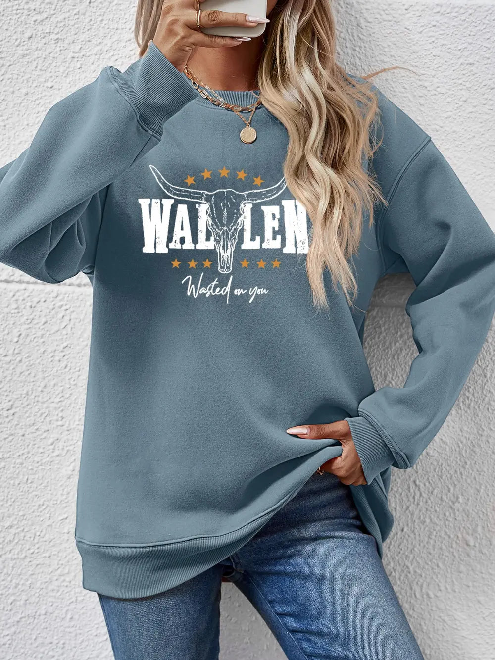 Misty Blue graphic sweatshirt with bull skull and text detail, drop shoulder, crew neck, casual fit.