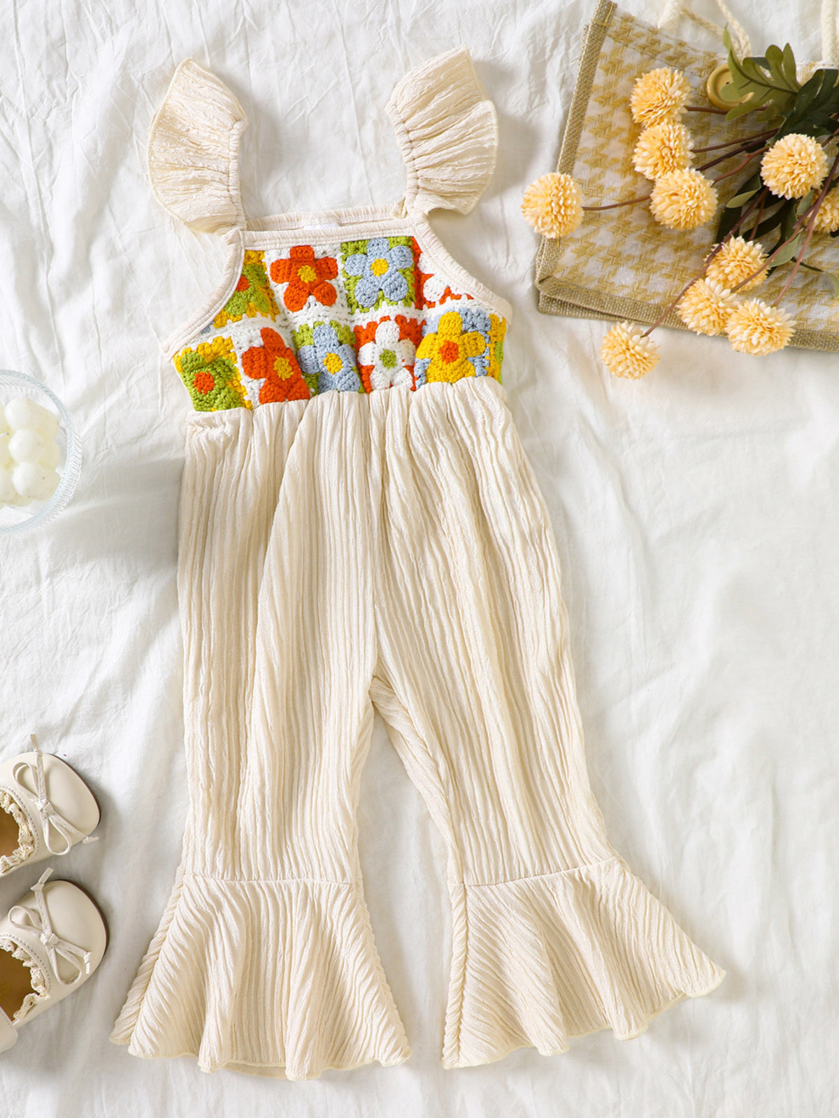 Cream crochet ruffle trim baby jumpsuit with floral bodice and bell bottoms