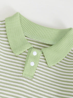Green and white striped polo shirt with waffle knit texture and two white buttons.