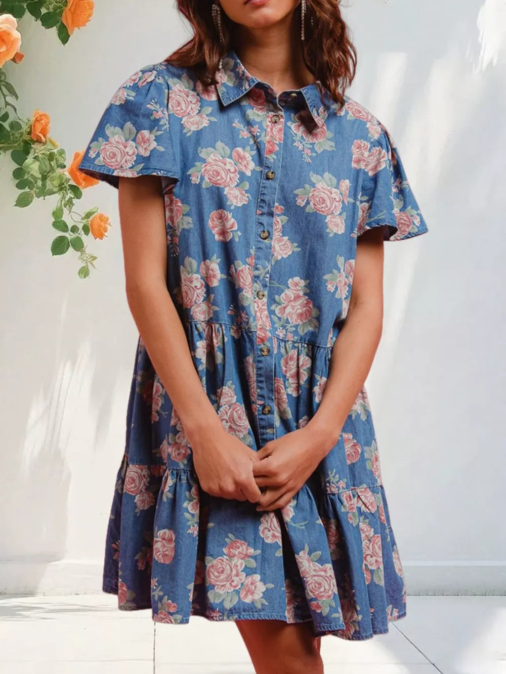 Floral denim mini dress with ruffled tiers and short sleeves.