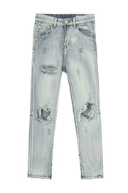Light wash distressed skinny jeans with ankle zippers and ripped details.