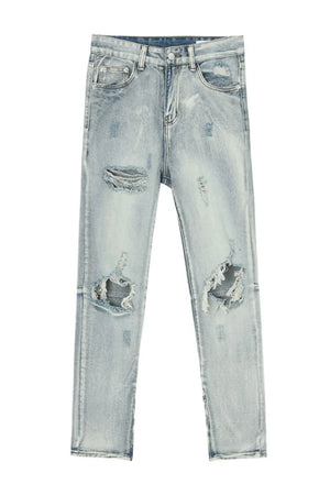 Light wash distressed skinny jeans with ankle zippers and ripped details.