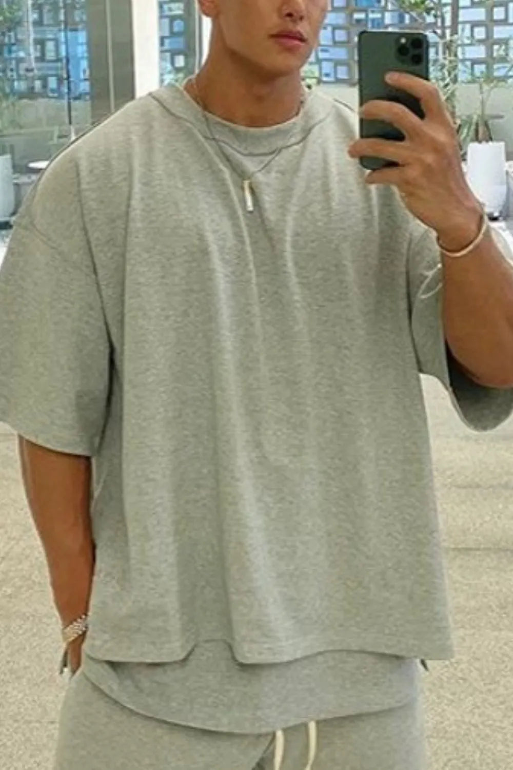 Gray oversized drop-shoulder tee with crew neck and short sleeves.