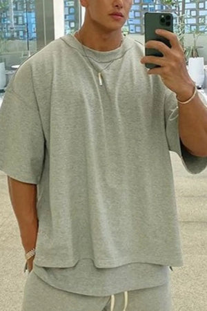 Gray oversized drop-shoulder tee with crew neck and short sleeves.