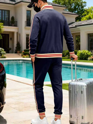 Navy blue tracksuit with red and white stripe accents on sleeves and legs.