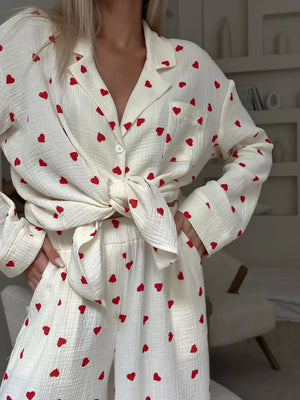 Pink pajama set with hip-length top, full-length pants and button-front