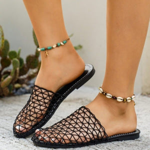 Black woven mule sandals with a net-like texture and comfortable flat sole.