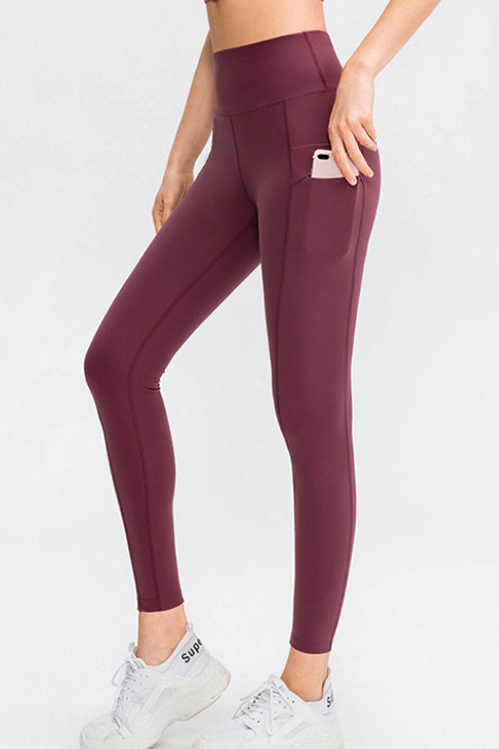 Wine athletic leggings with side pockets and a high waist.