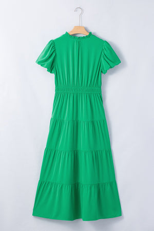 Green maxi dress with puff sleeves, ruffled neckline, and tiered skirt.