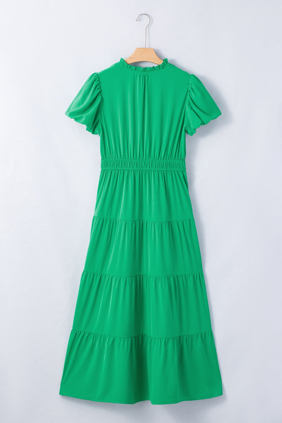Green maxi dress with puff sleeves, ruffled neckline, and tiered skirt.