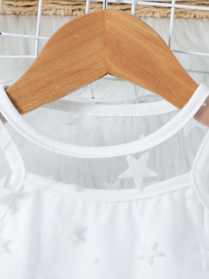 White cotton cami with sheer mesh overlay and embossed stars, round neckline.