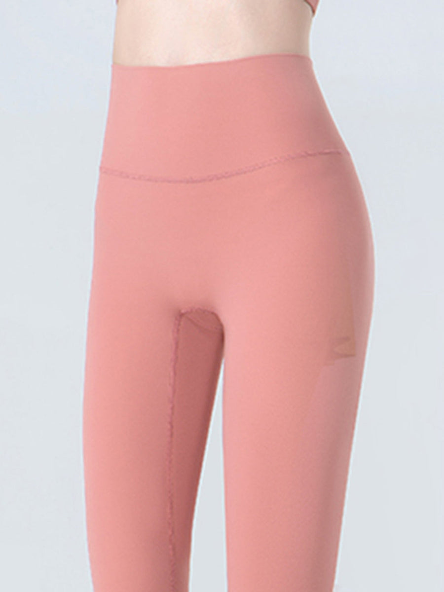 Sculpted crop leggings in coral with subtle mesh detail on the side.