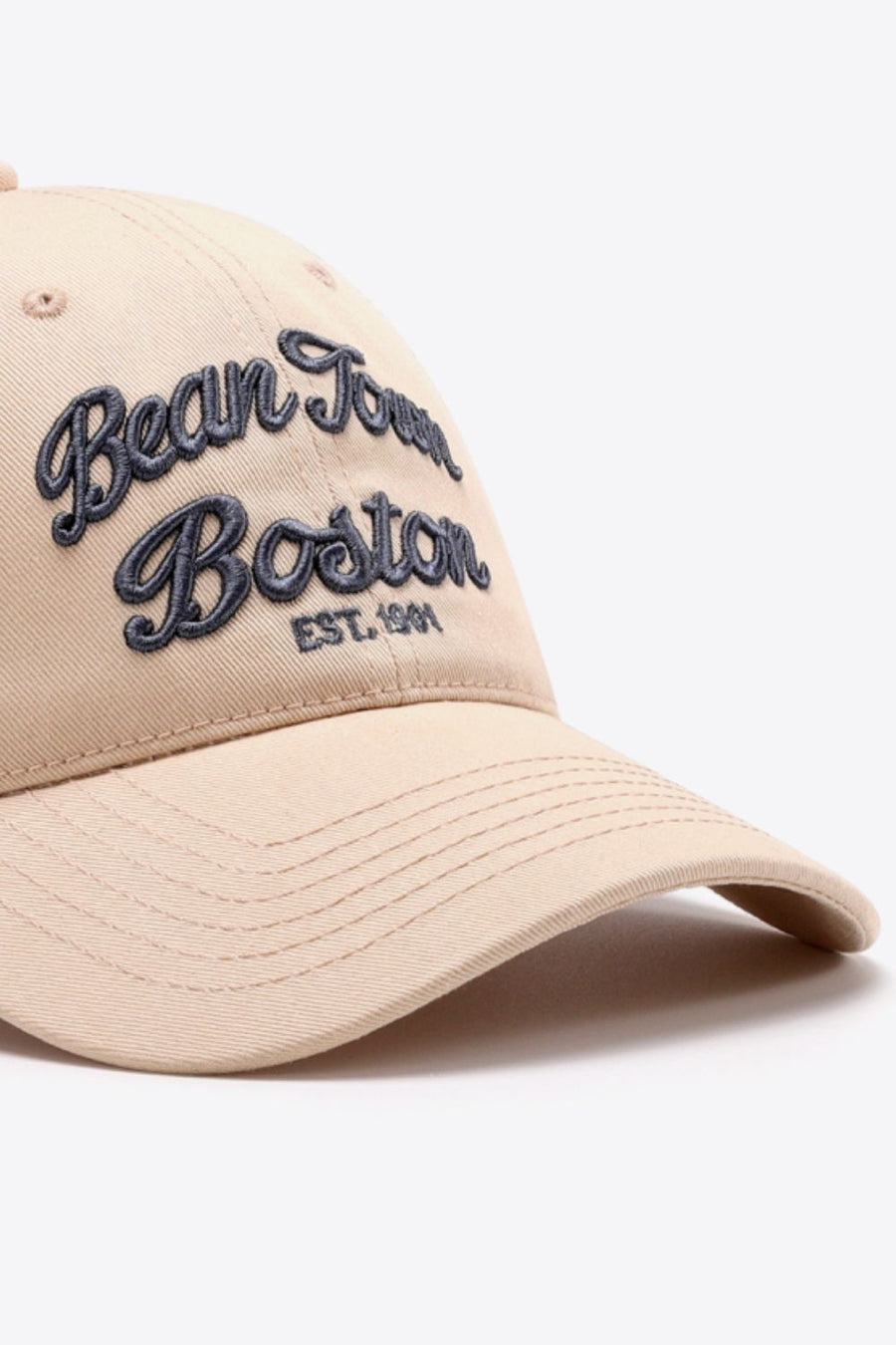 Tan baseball cap with embroidered "Bean Town Boston" in dark blue script.
