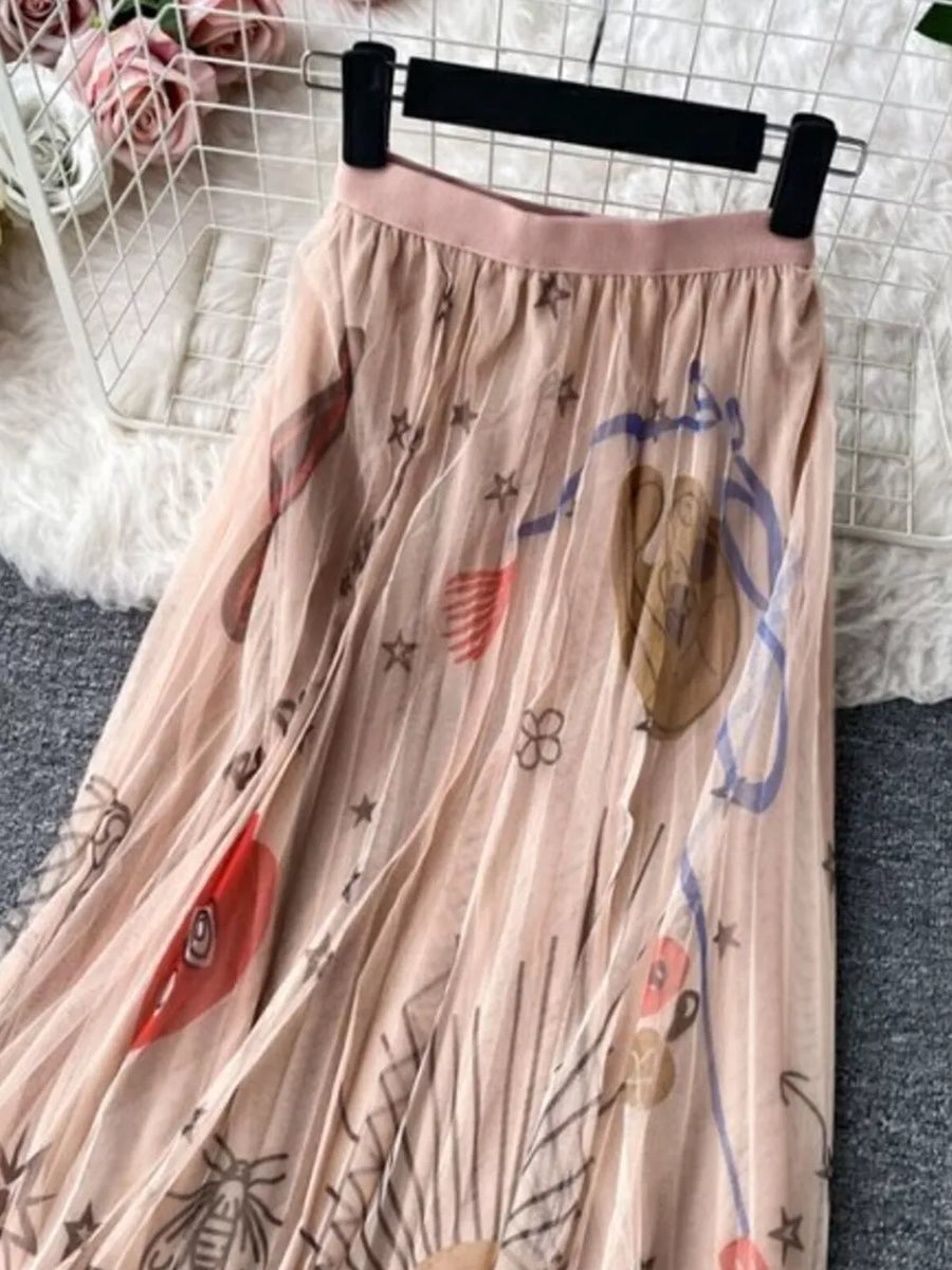Pink pleated tulle skirt with abstract sunburst print and stars.