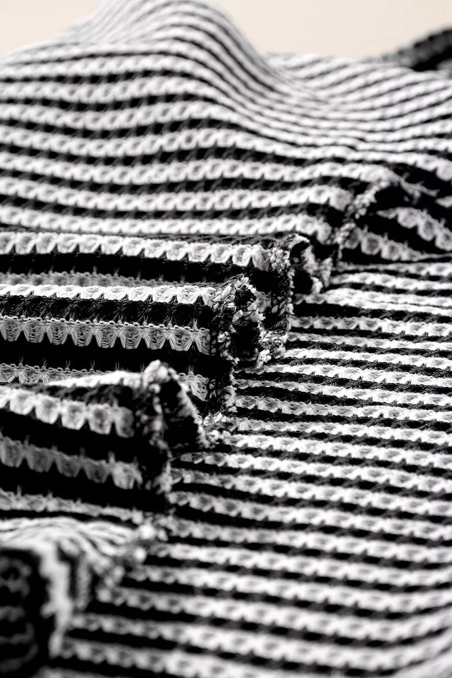 Textured knit t-shirt with horizontal stripes and a waffle weave pattern.