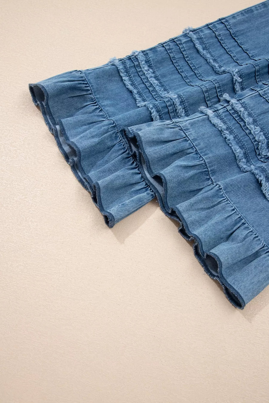 Maternity wide-leg jeans in denim with ruffled hem and frayed detailing.